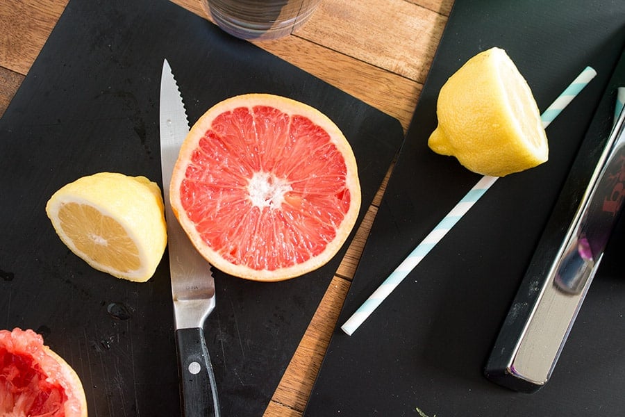 Half of a grapefruit and a lemon cut into two halves