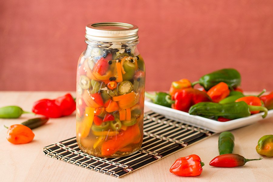 Pickled chili peppers, jarred and ready for consumption.