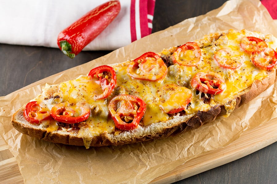 This Jalapeno Popper Pizza Bread Recipe is ready to serve! LOTS of jalapeno peppers.