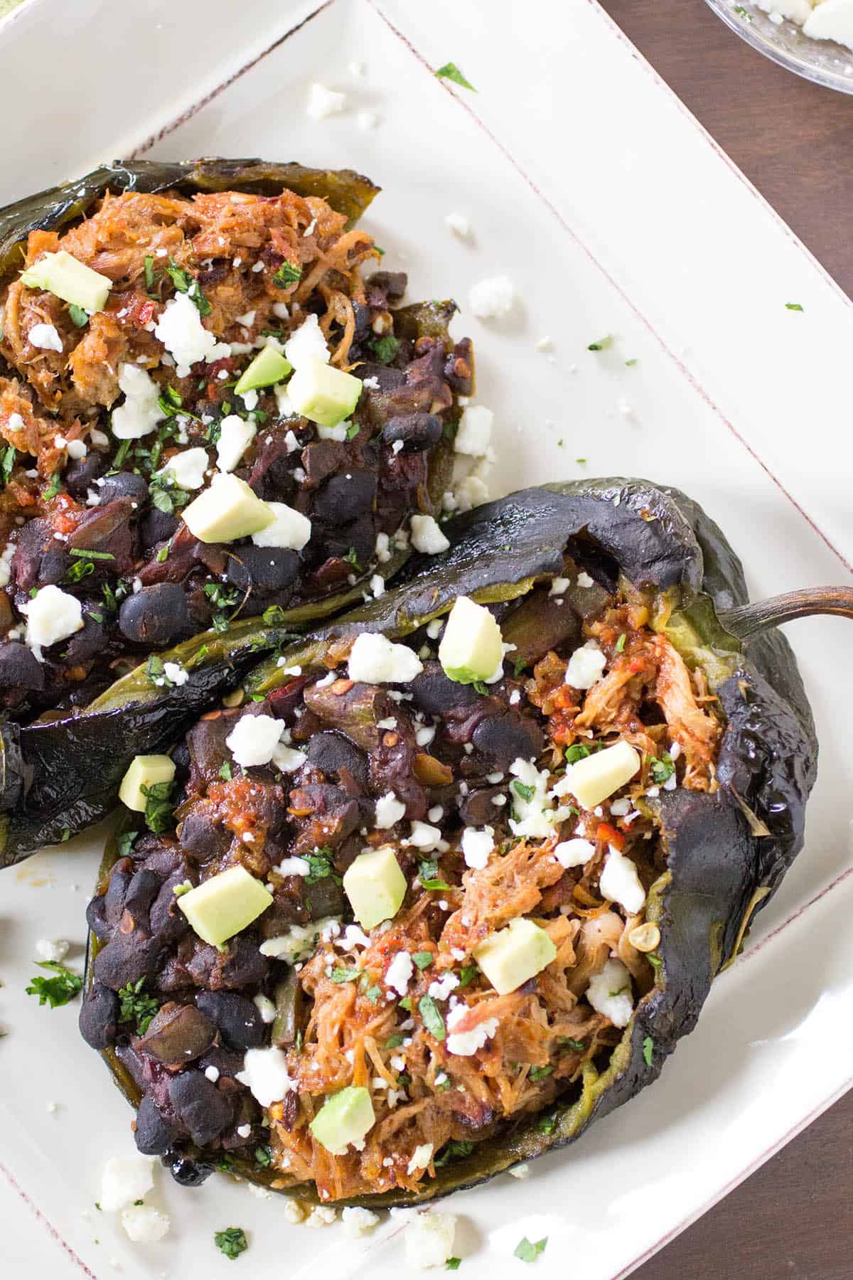 tex-mex chipotle pork and black bean stuffed poblano peppers