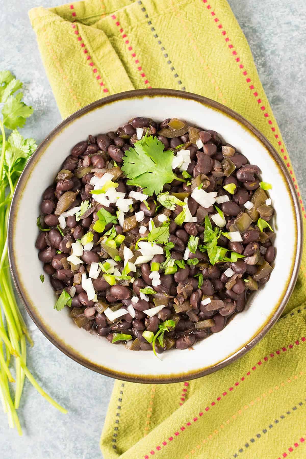 Frijoles Negros (Cuban Black Beans) in a bowl with garnish