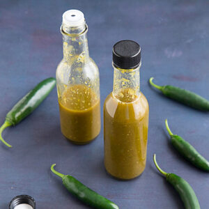 Spicy Serrano Hot Sauce served in two bottles