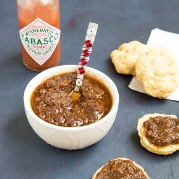 Bacon Onion Jam served in a bowl and on crackers.