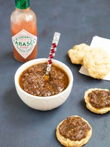 Bacon Onion Jam served in a bowl and on crackers.