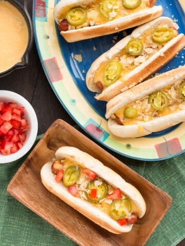 The Ultimate Nacho Cheese Dog served with sides.