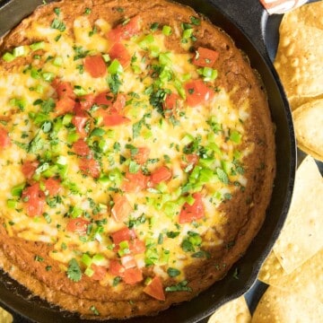 Easy Cheesy Chipotle Bean Dip served with chips.