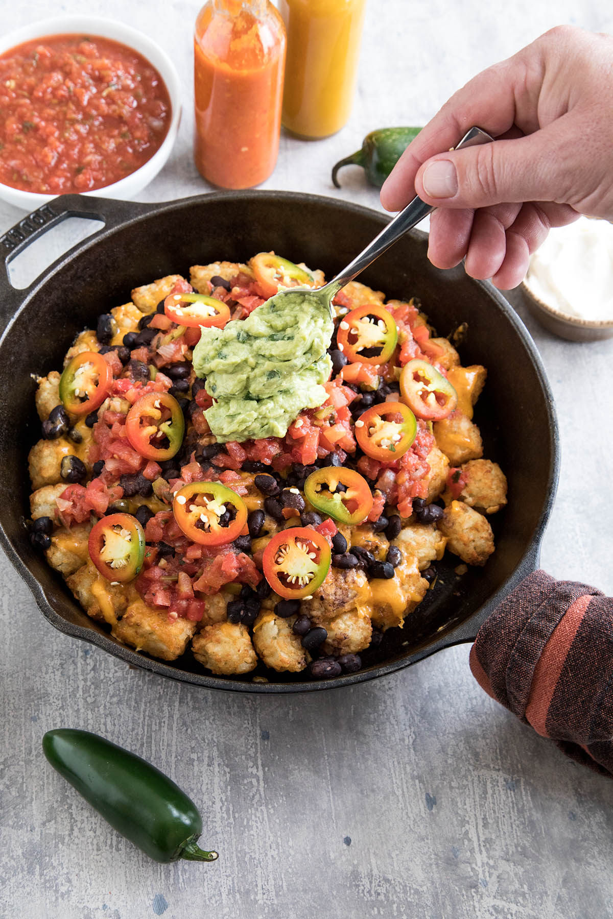 Adding guacamole to the skillet.