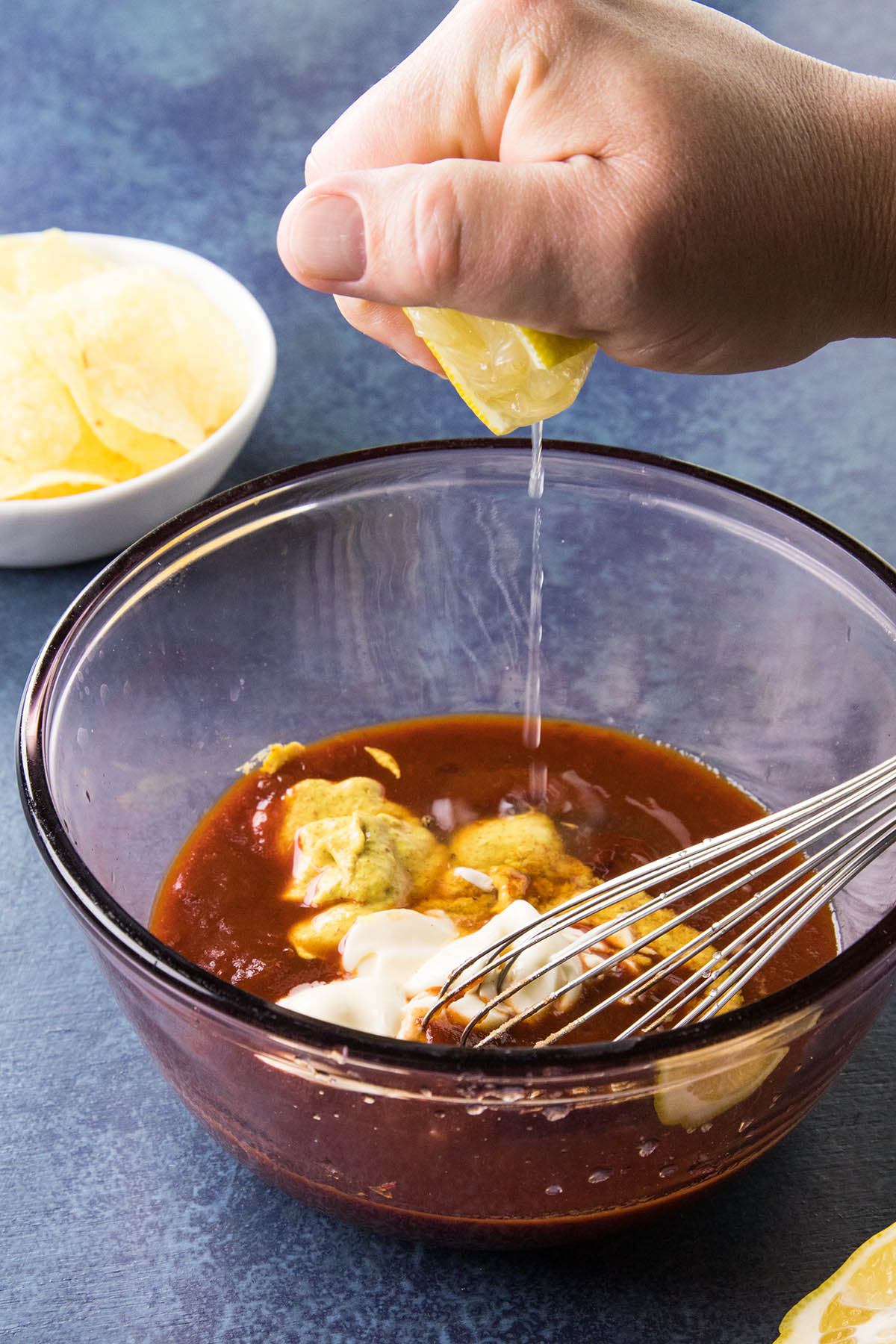 Adding lemon juice to the bowl.