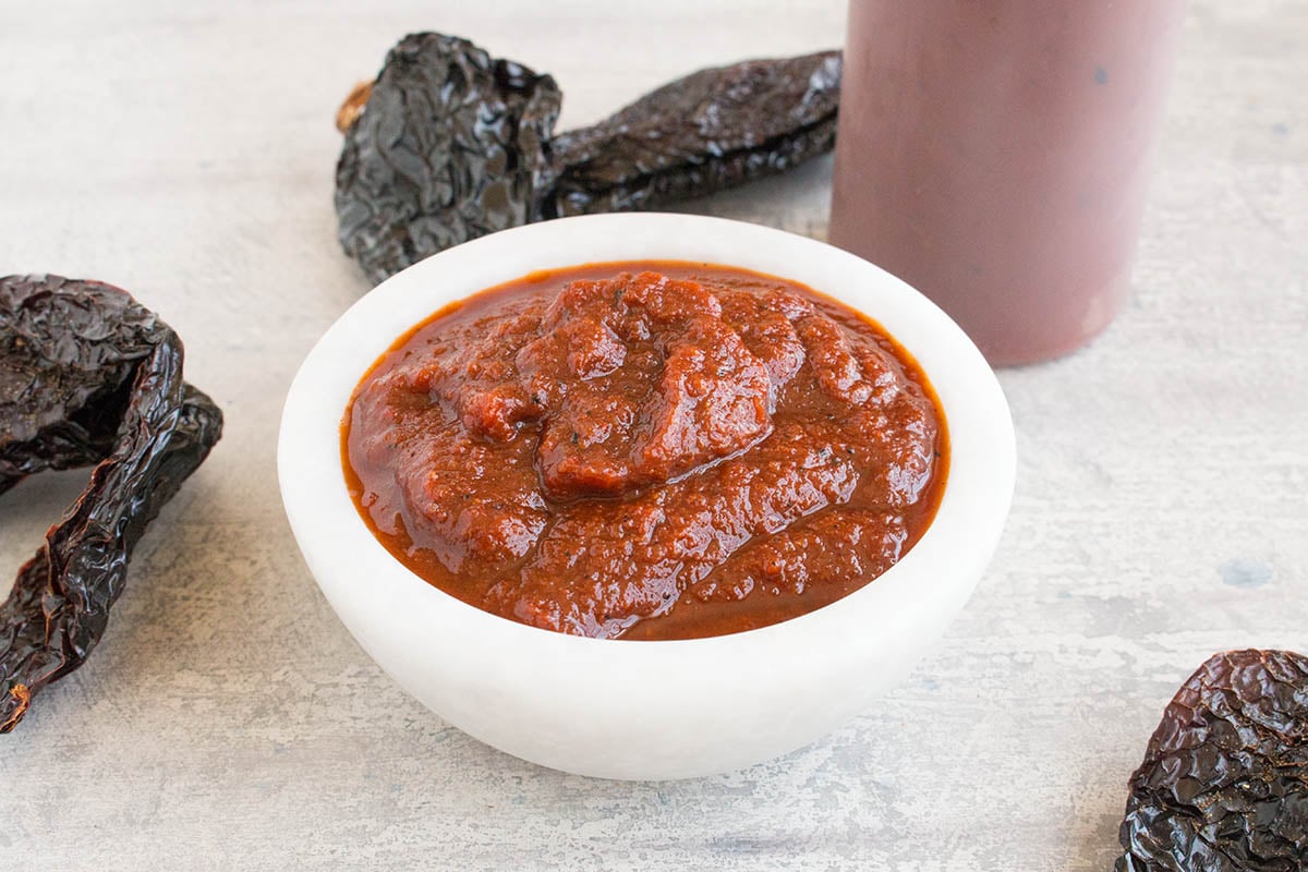 Ancho BBQ Sauce served with peppers around the bowl