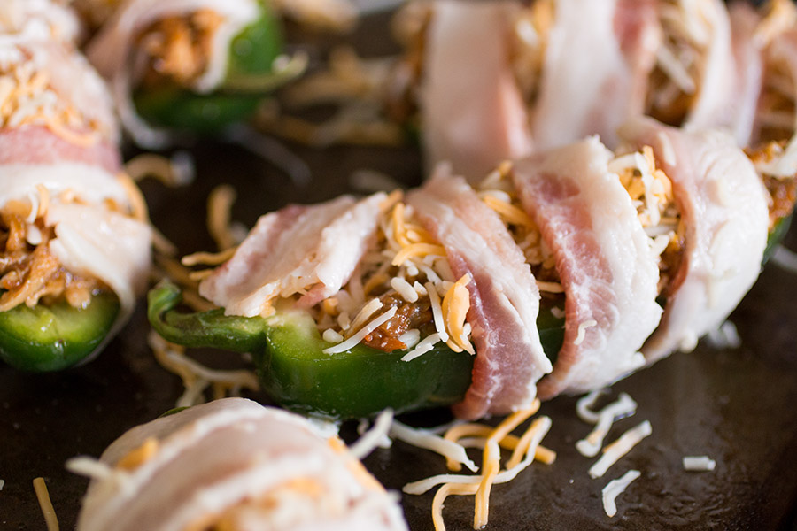Gently wrap your jalapeno poppers in bacon, like this , then bake them.