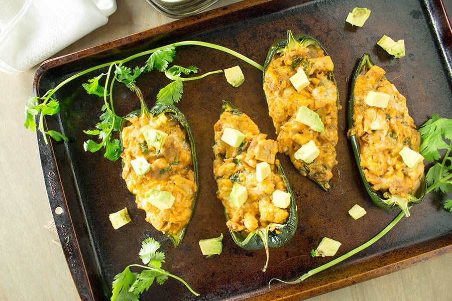 Four Cajun Chicken Stuffed Poblano Peppers in a big skillet