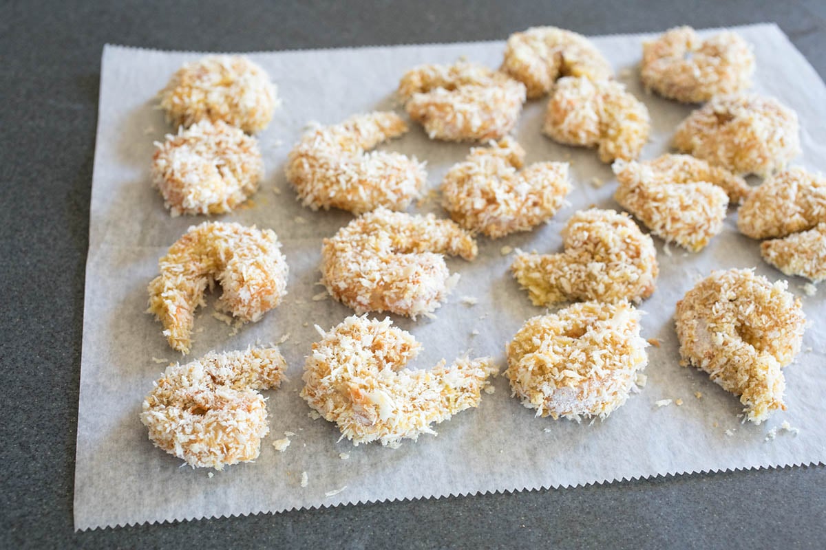 All shrimp is coated and ready on a piece of parchment paper.