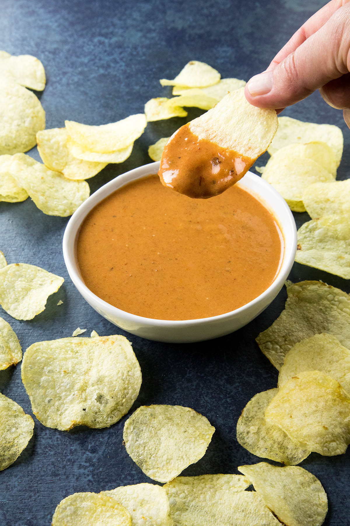 Dipping a chip into the Chipotle Honey Mustard Dip.