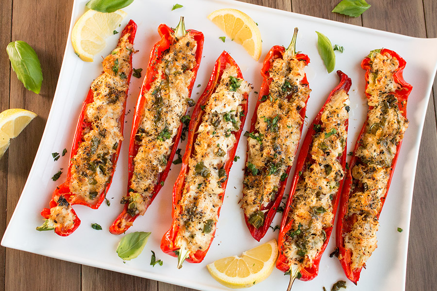 Crab Stuffed Peppers with Lemon-Basil Butter served on a tray