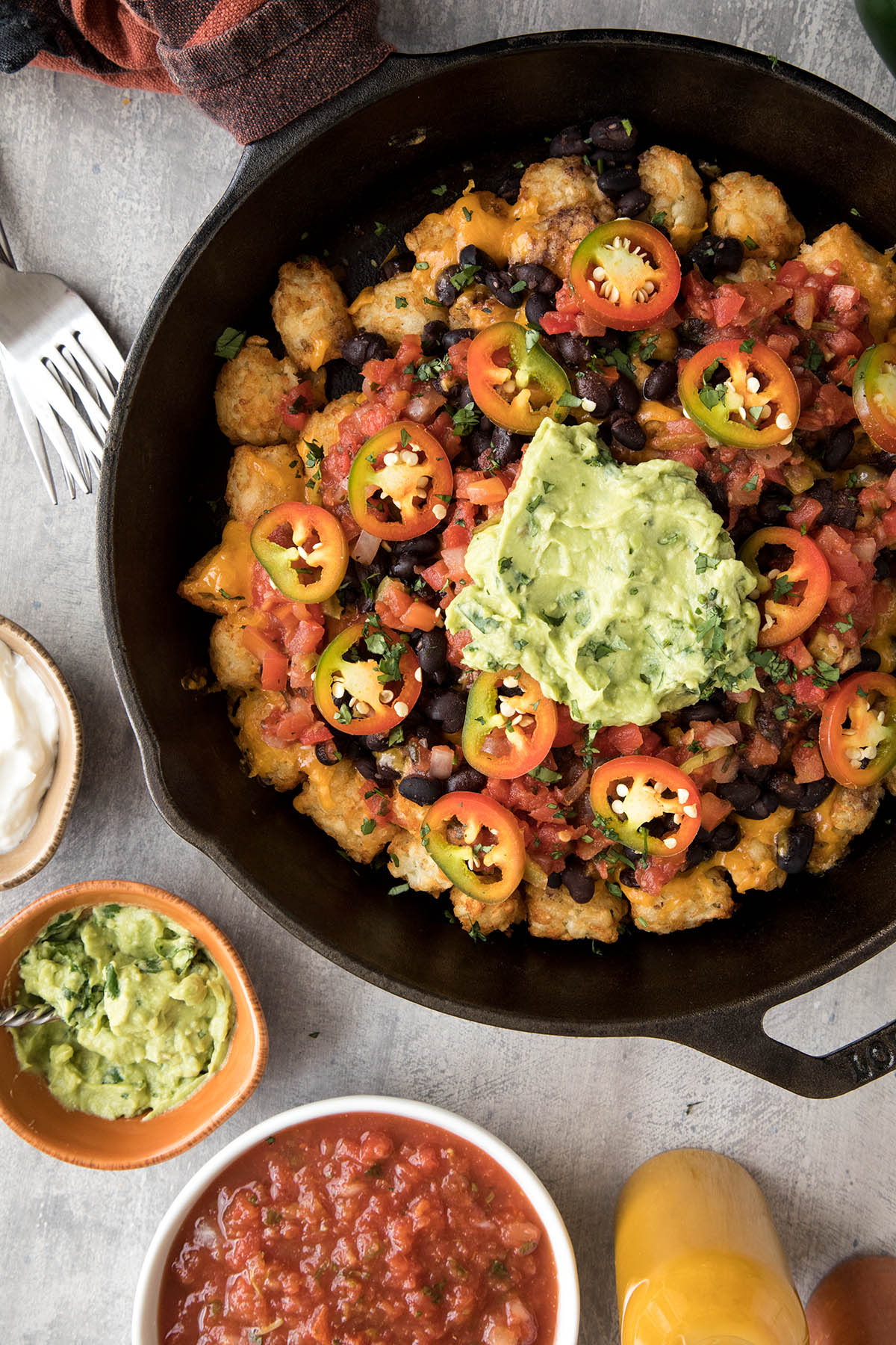 Easy Cheesy Game Day Totchos (Tater Tot Nachos) in a skillet.