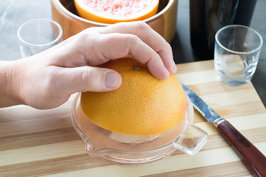 Squeezing the grapefruit to make Grapefruit Kamikaze