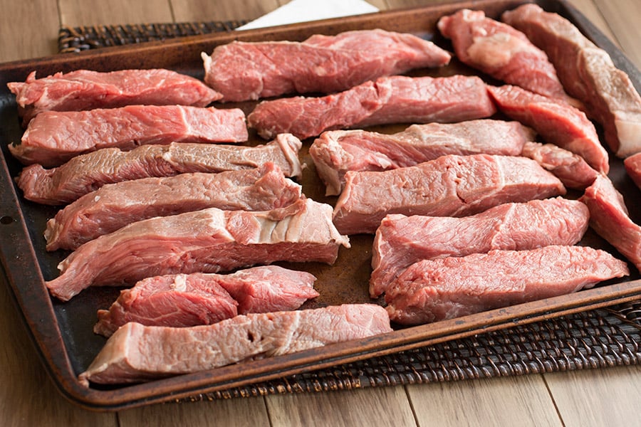 Meat ready to be grinded, on a tray.