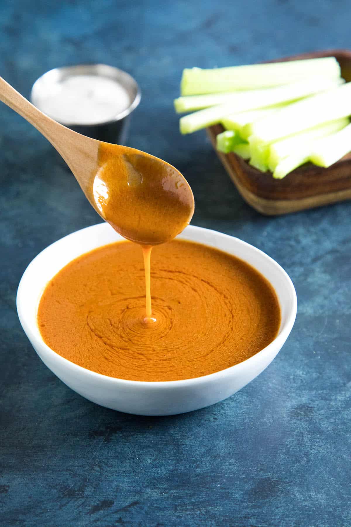 A spoonful of the delicious buffalo sauce in a bowl