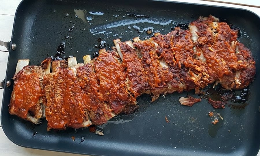 Homemade Peach-Bourbon Barbecue Sauce on pork ribs.