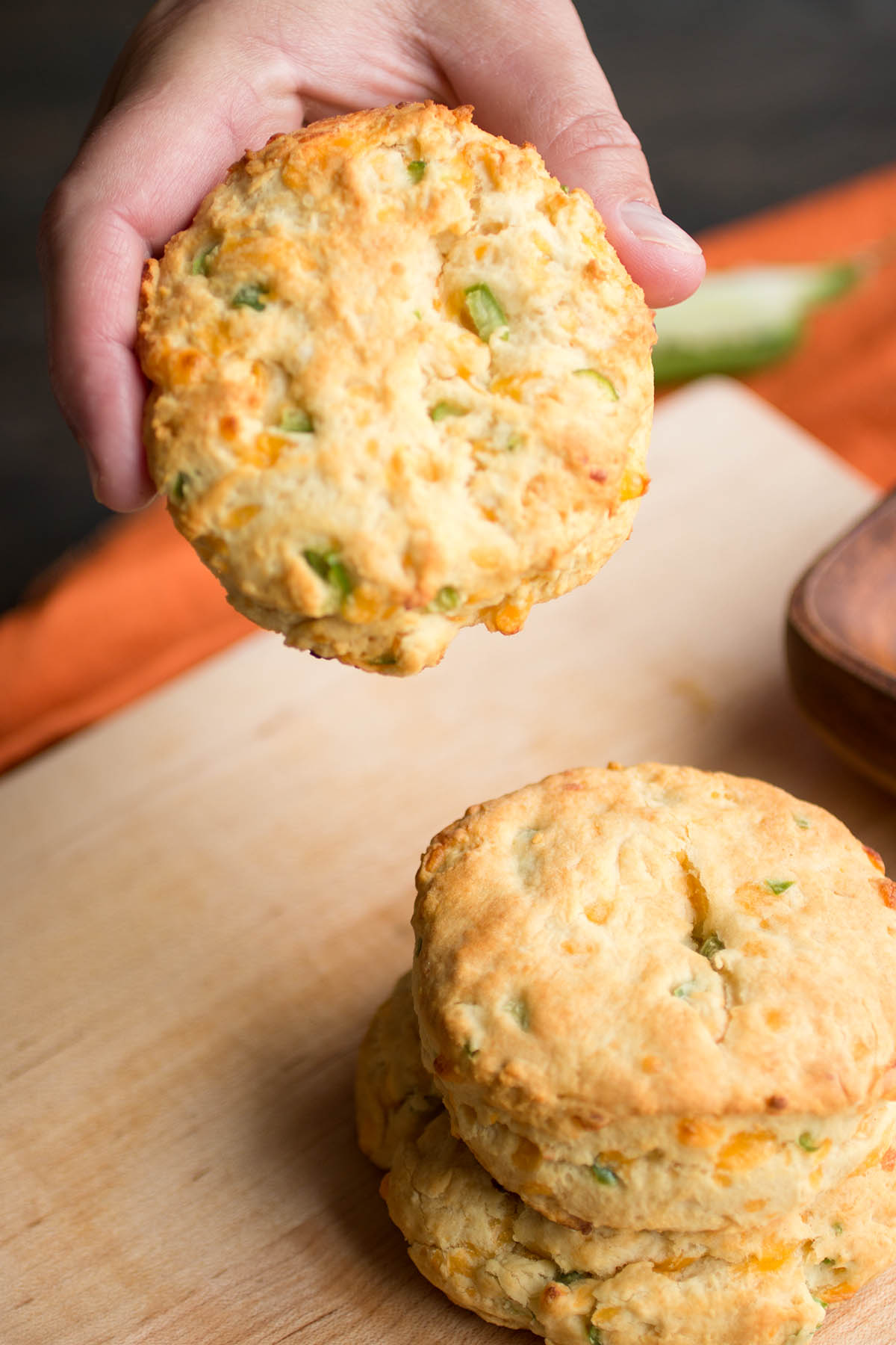 Holding one of the Homemade Cheddar-Jalapeno Biscuits