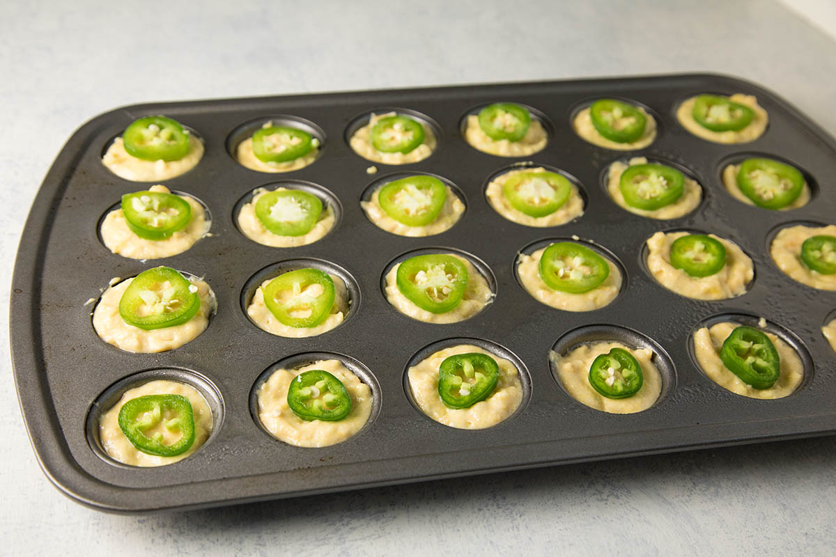 A tray of Cheesy Jalapeno Popper Cornbread Muffins ready for baking.