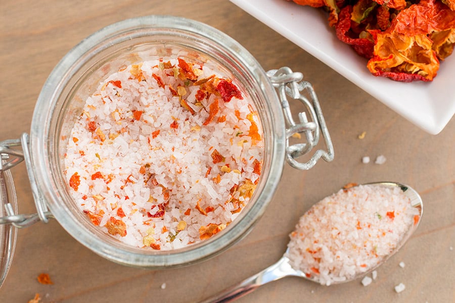 Homemade Superhot Salt in a small jar and a spoon