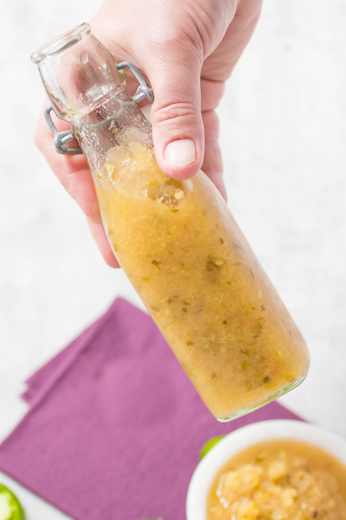 Holding a jar of the Pineapple-Jalapeno Hot Sauce