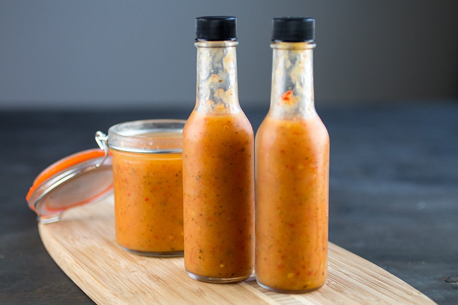 Pineapple-Mango Ghost Pepper Hot Sauce served in three different jars