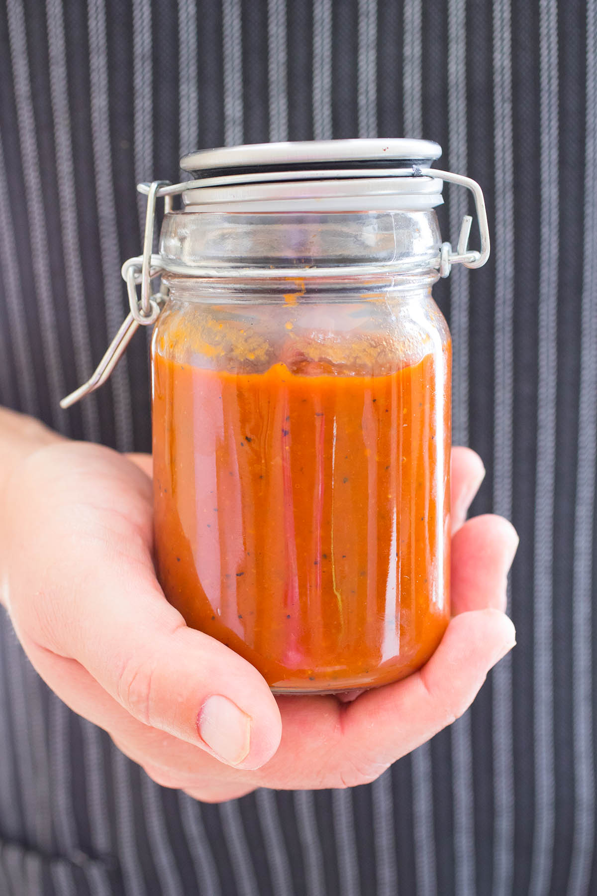 Holding a big jar of the delicious Pineapple-Mango Ketchup in hand