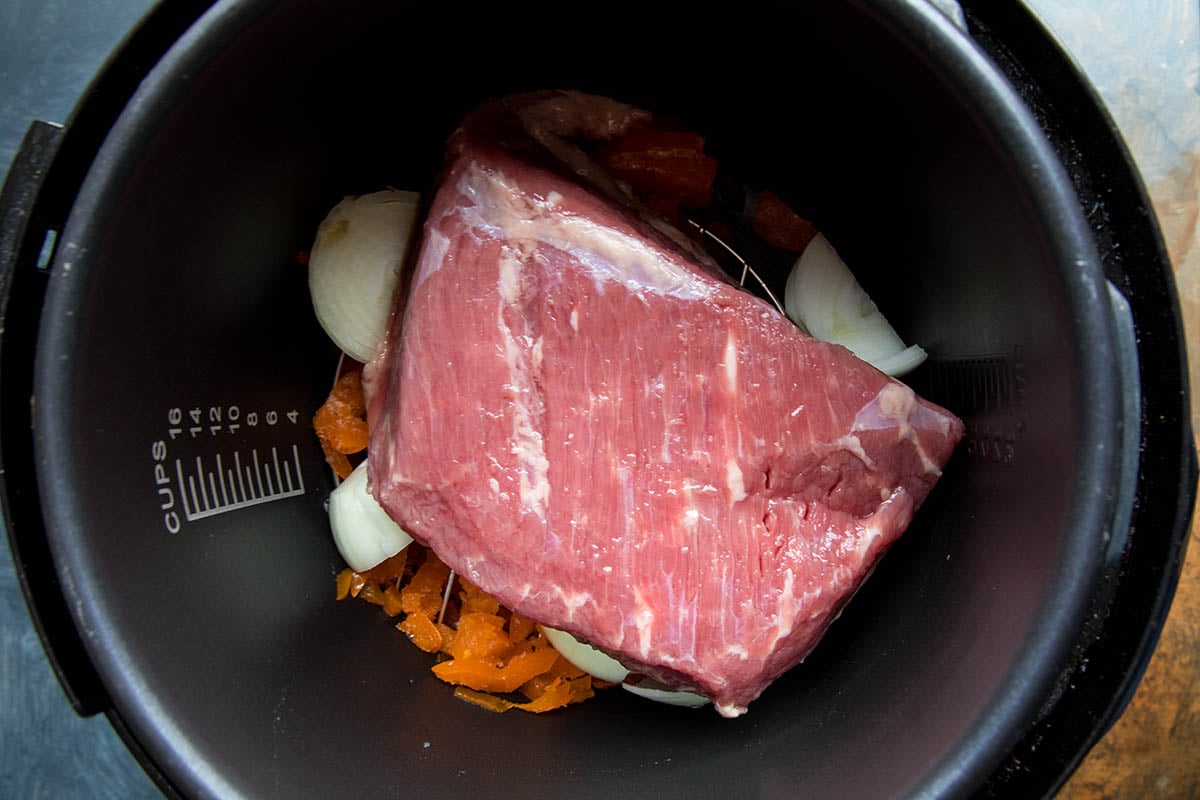 Corned Beef in the Pressure Cooker with peppers, onion, garlic cloves and your preferred seasoning.