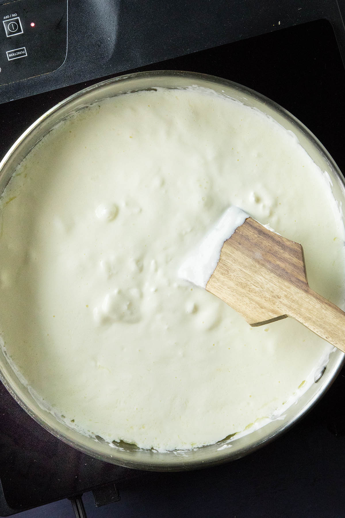 Heat the cream cheese with crema or sour cream and butter in pan.