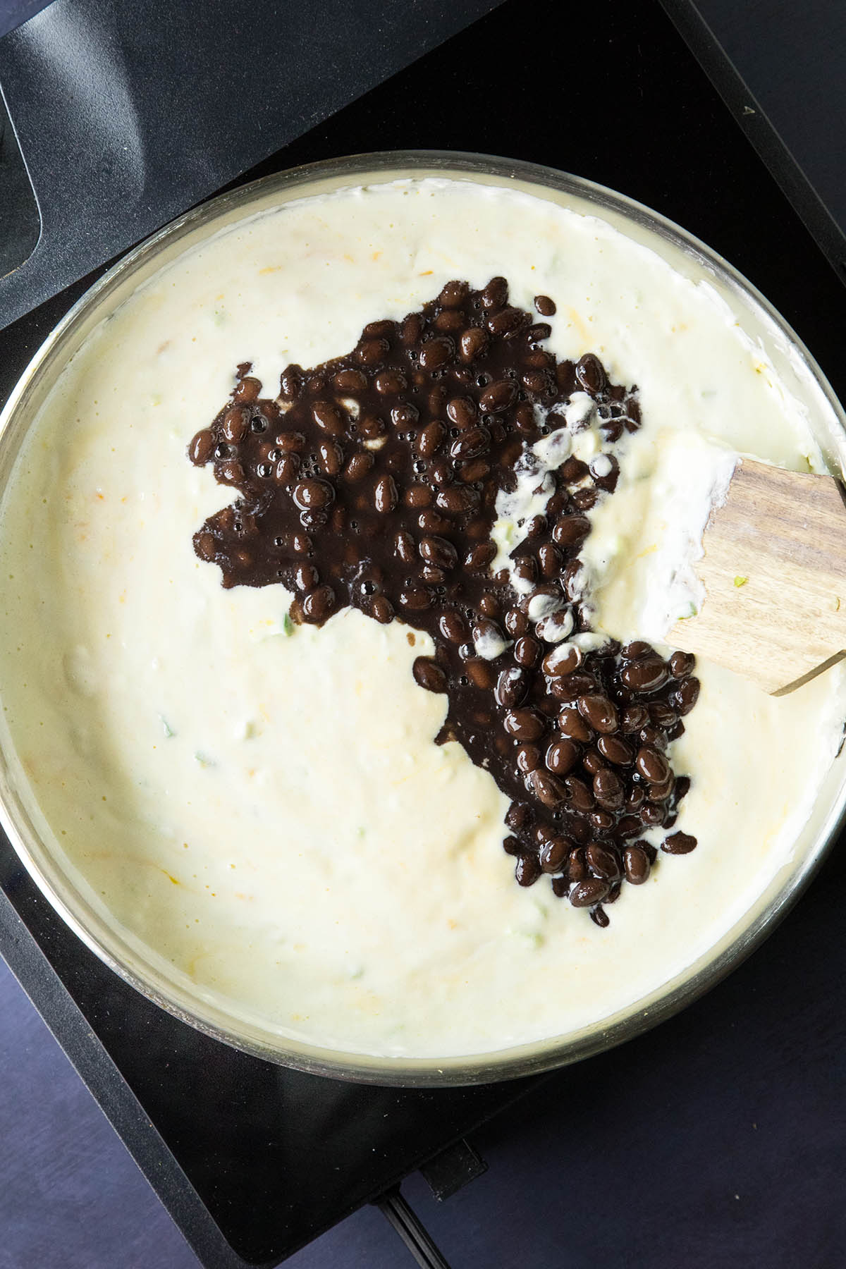 Swirling in the black beans and seasonings.