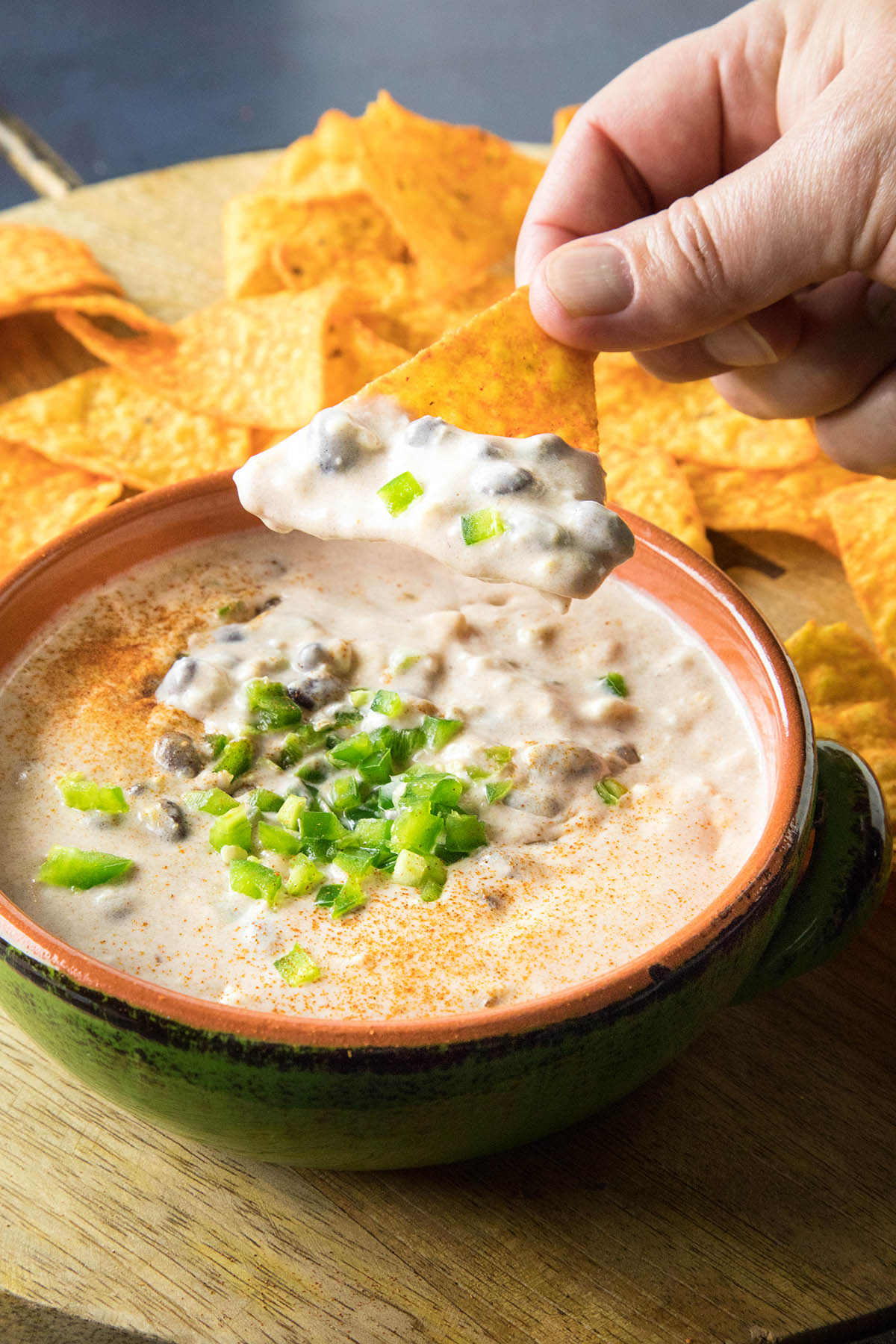 Dipping a chip into the Southwest Style Cheese Dip.