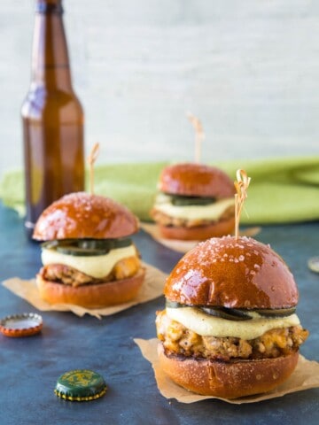 Ground Pork Sliders with Mustard Cream and Quick Pickled Cucumbers served