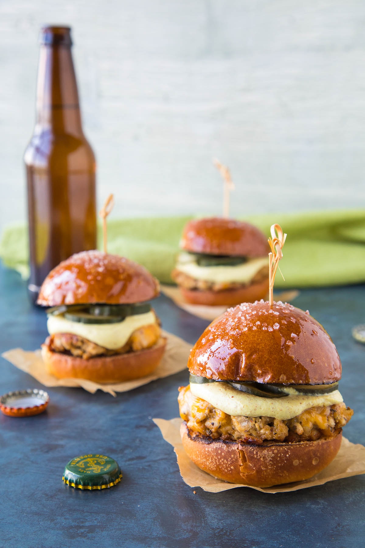 Ground Pork Sliders with Mustard Cream and Quick Pickled Cucumbers served