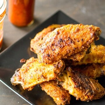 Superhot Chicken Wings served with hot sauce on the side.