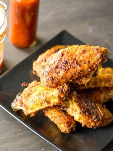 Superhot Chicken Wings served with hot sauce on the side.