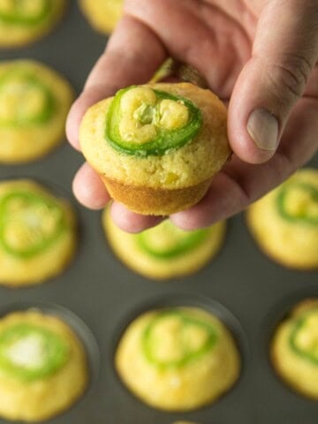 Holding one of the Cheesy Jalapeno Popper Cornbread Muffins