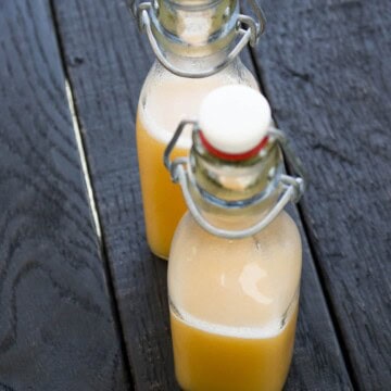 Peach Sugar Rush Hot Sauce served in two jars on the wooden surface