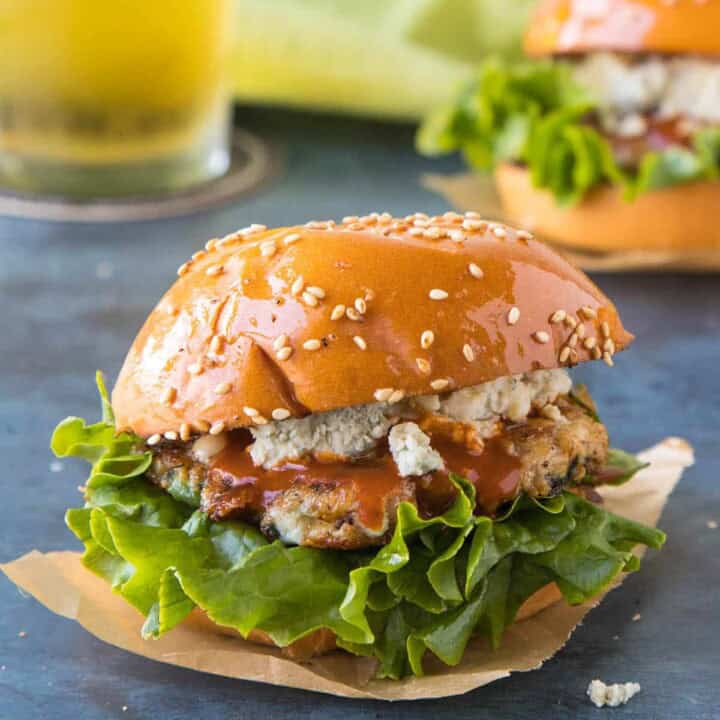 Ground Chicken Sliders on a plate, ready to serve, with lots of crumbly blue cheese