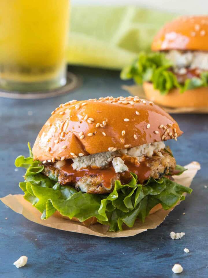 Ground Chicken Sliders on a plate, ready to serve, with lots of crumbly blue cheese