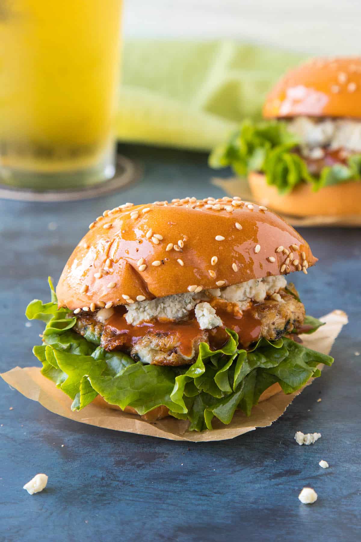 Buffalo Chicken Sliders on a plate, ready to serve, with lots of crumbly blue cheese