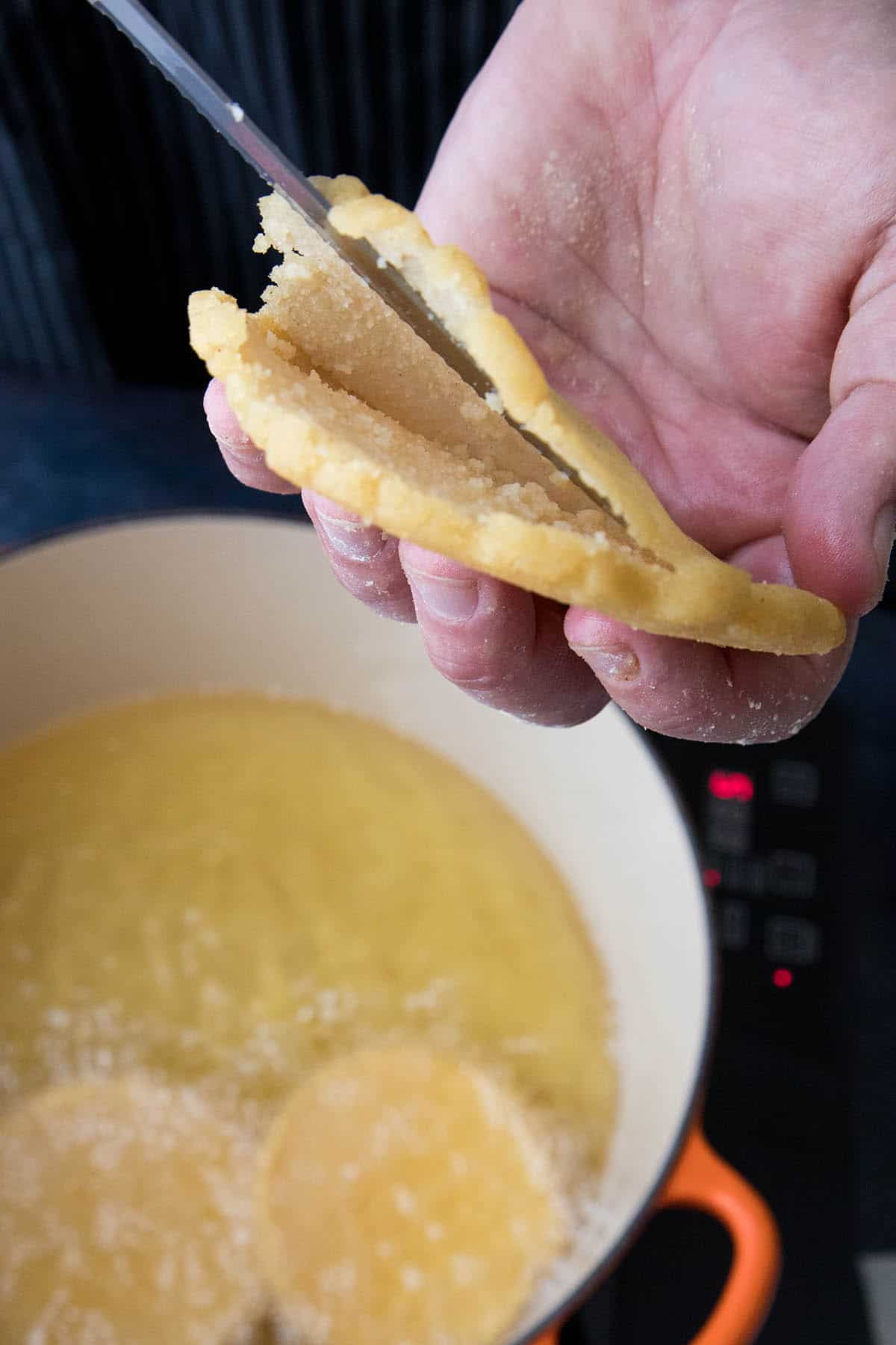 Slicing a Mexican Gordita to prepare it for filling