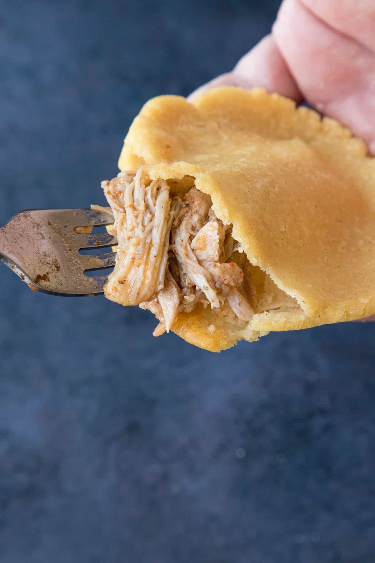 Stuffing a Mexican Gordita with delicious pulled chicken