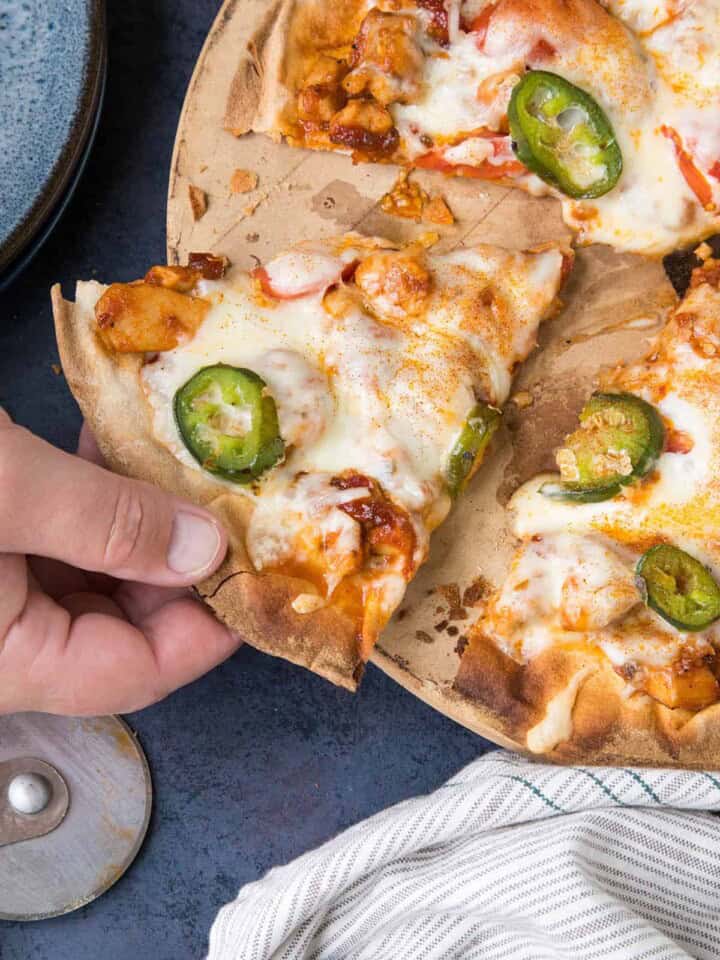 Grabbing a piece of the BBQ Chicken Pizza.
