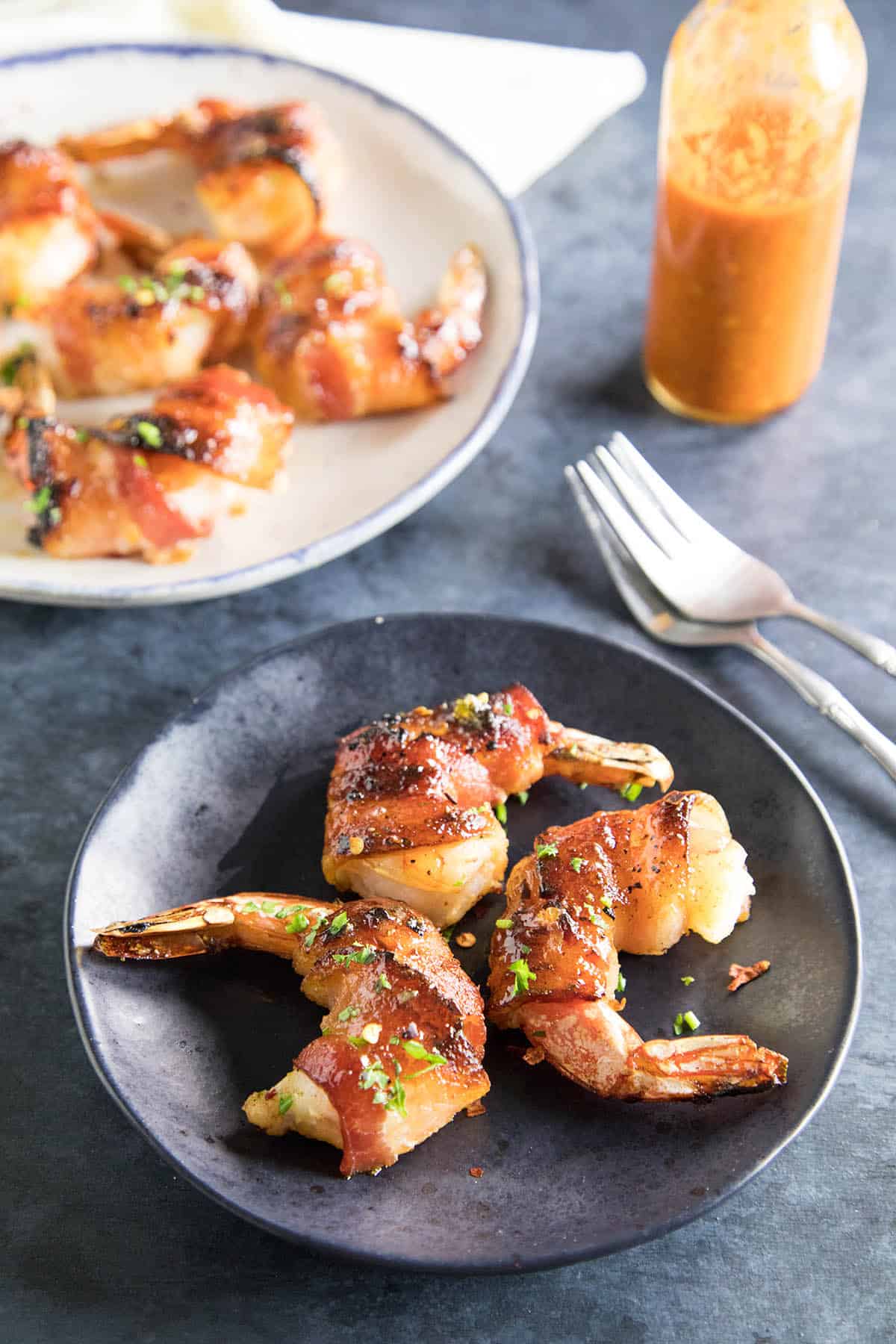 Habanero-Honey Glazed Bacon Wrapped Shrimp served on a plate.