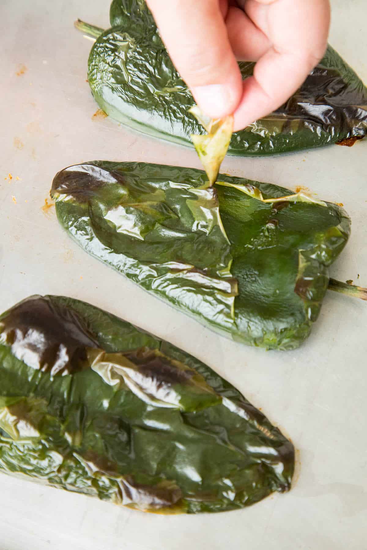 Peeling the skin from the roasted peppers