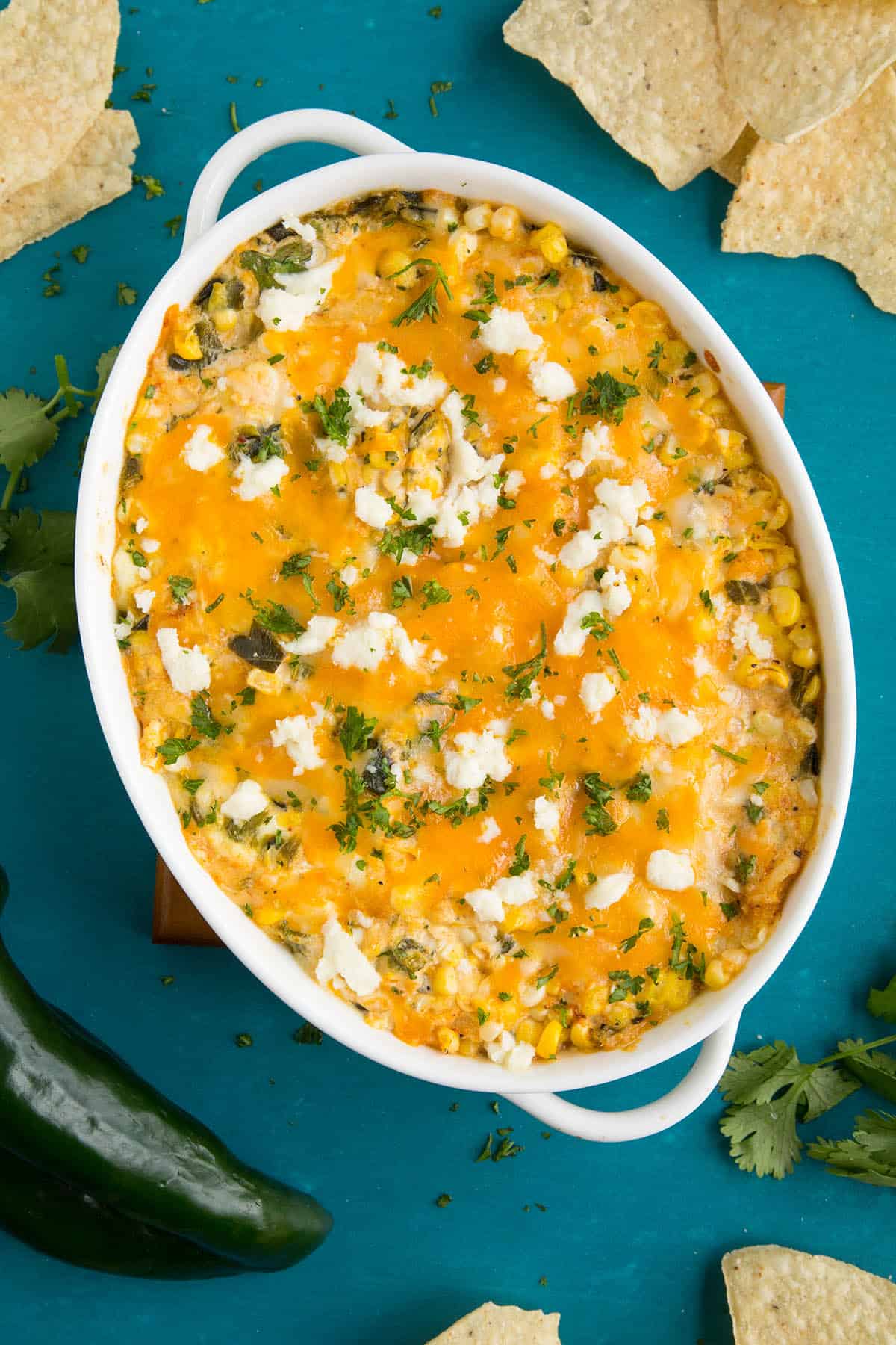 This cheese dip is ready to serve, with roasted poblano peppers and corn.