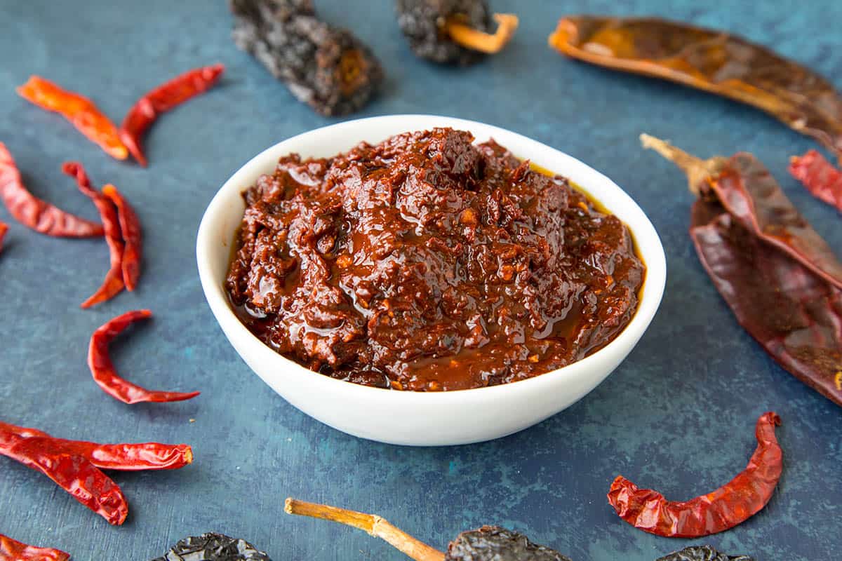 Homemade Harissa in a while bowl - made from dried peppers, toasted herbs and spices
