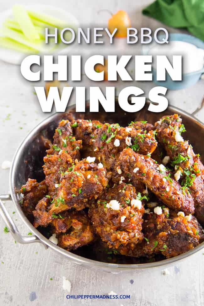 Crispy Baked Honey BBQ Chicken Wings - These honey-bbq chicken wings are seasoned then baked until nice and crispy, then slathered in honey-barbecue sauce that is sweet, spicy and has just the right amount of tanginess. Here is the recipe. Perfect for parties or any night of the week. | ChiliPepperMadness.com #chickenwings #wings #partyfood #bbqwings